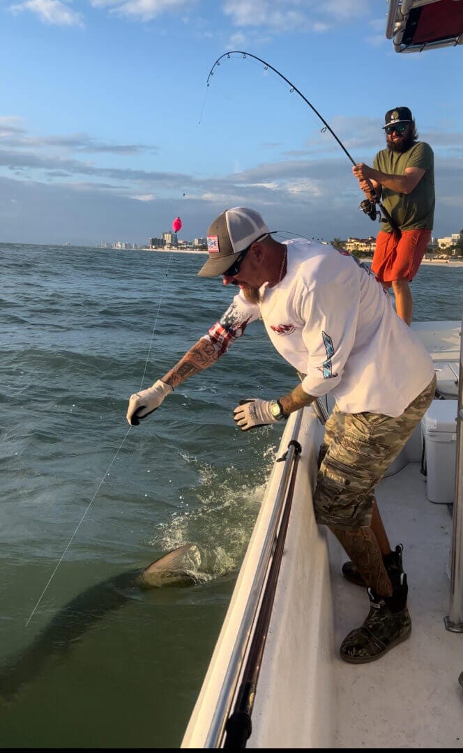 Fishing adventure at sea with anglers landing a catch, only available at Salty Dog Fishing Charters-Johns Pass-Treasure Island.